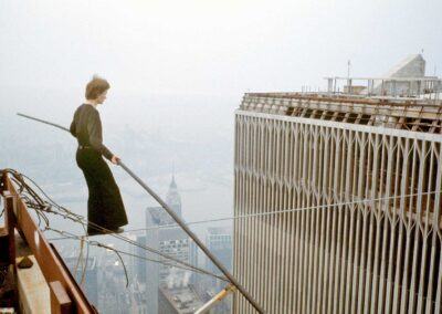 A tightrope walker walking between the towers of the World Trade Centre